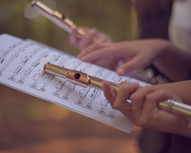a person holding a flute and playing flute