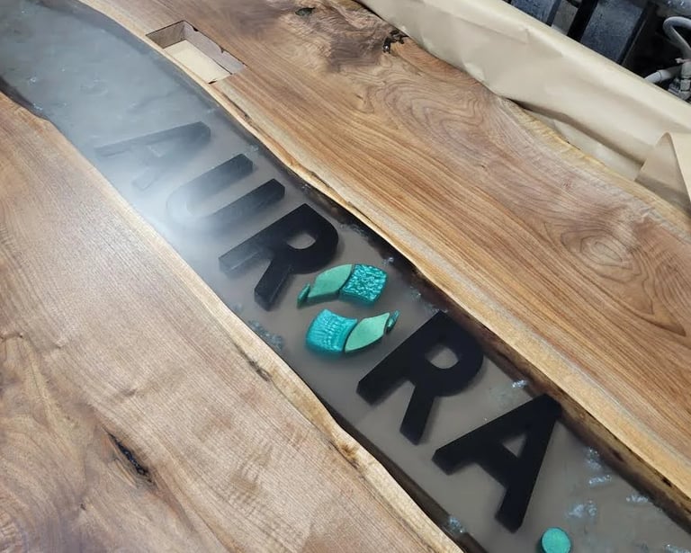 Custom live edge black walnut epoxy river boardroom table — top view with logo insert option