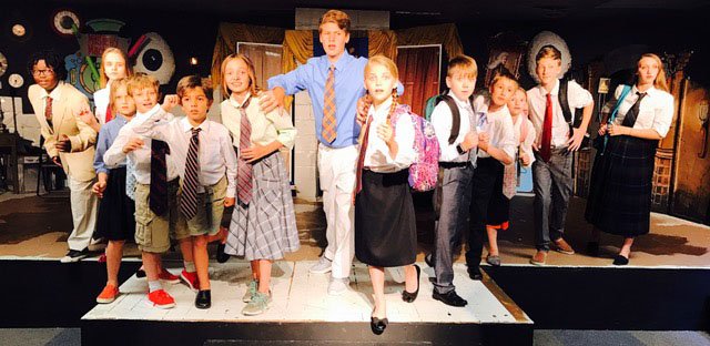 Student performing Sherlock Holmes on stage