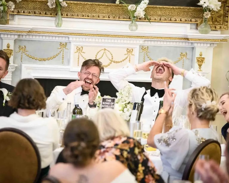 same-sex couple enjoying speeches after their wedding at The Trafalgar Tavern Greenwich
