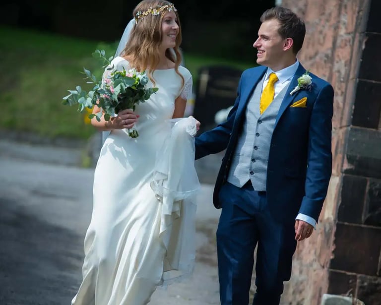 bride and groom walking around church grounds
