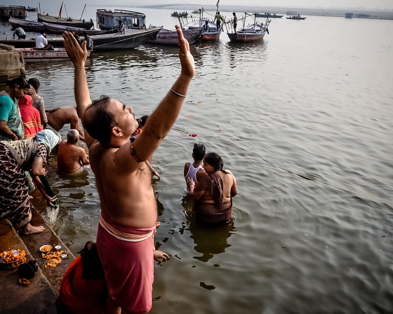 Early morning prayer to the sun and the waters of the Ganges in Varanasi, India.