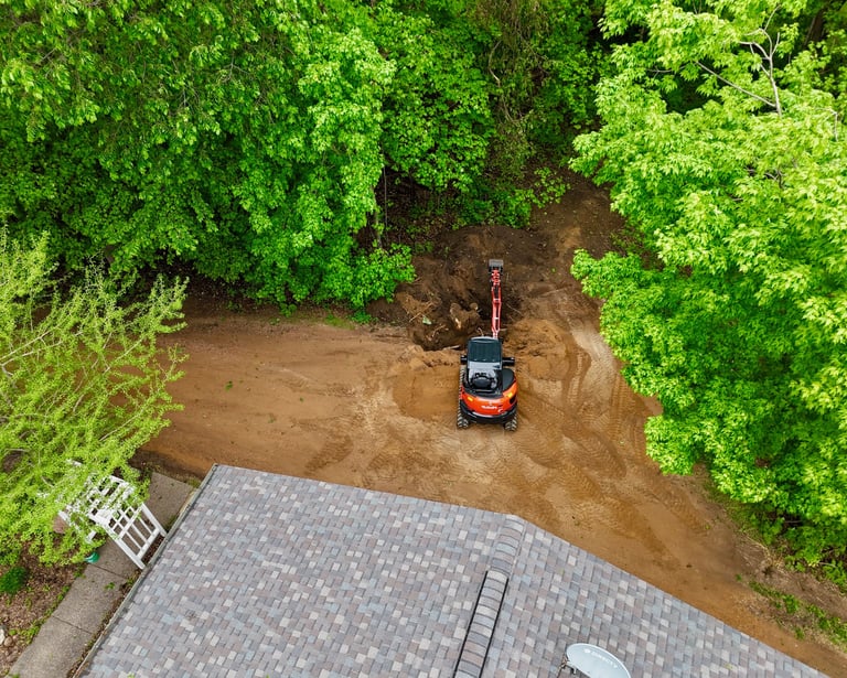 Kubota excavator digging dirt at residential home in central mn