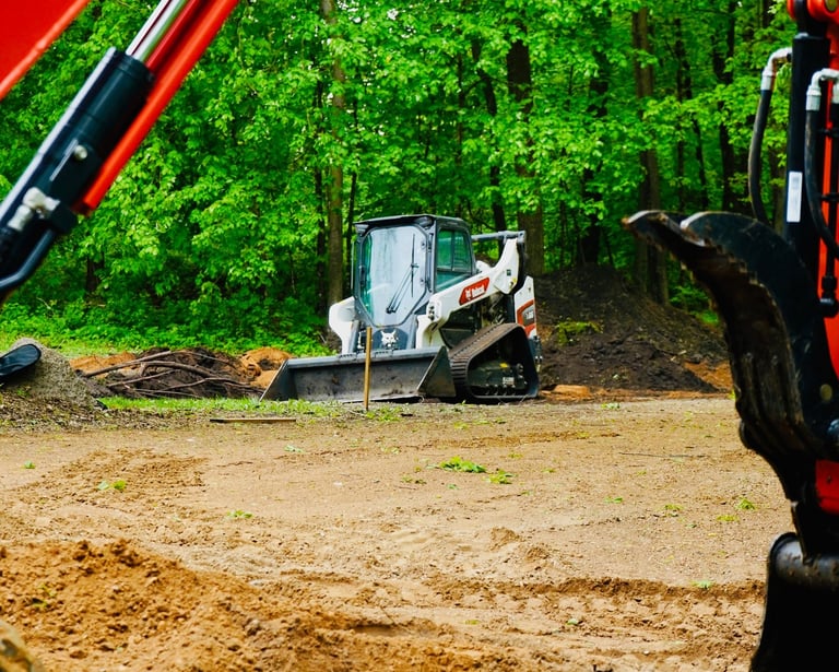 bobcat skid steer grading gravel lot in central mn