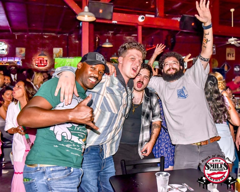 Bachelor party guests singing along during an interactive dueling piano show at Savannah Smiles in S