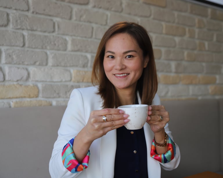 a japanese woman in a white jacket and colorful bracelets