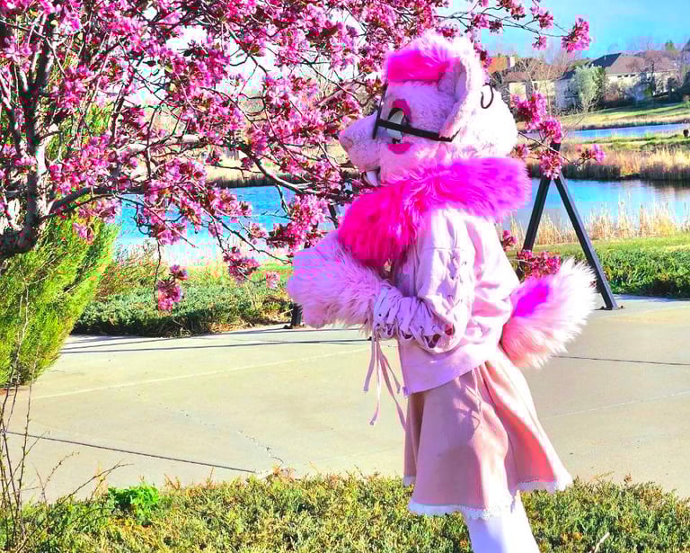Elenor; a pink fursuiter is smelling a chery blosom tree Elenor Is a new member of the Teto Creation