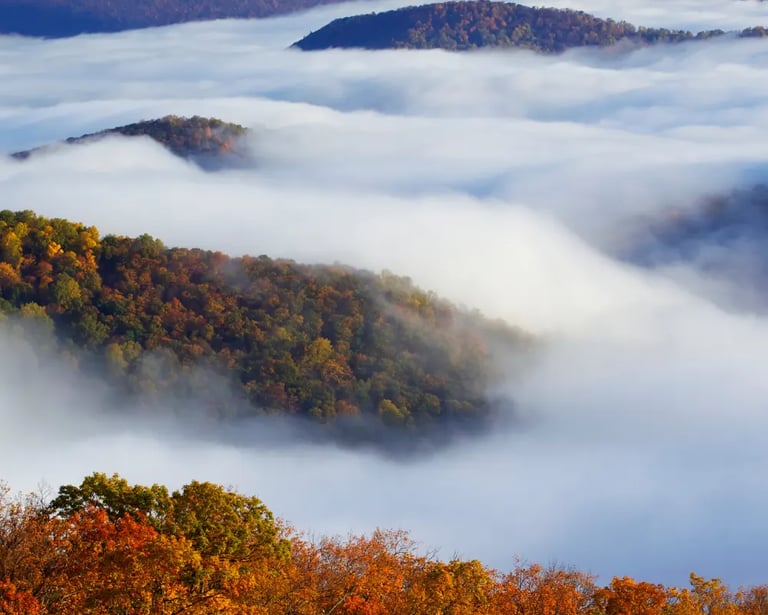 a mountain range with a view of the clouds