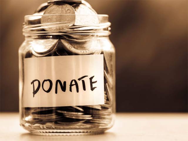 a jar of coins says donate green Way Association