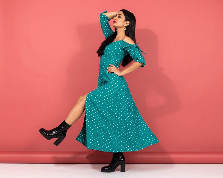 a woman in a polka dot dress with a polka dot print dress