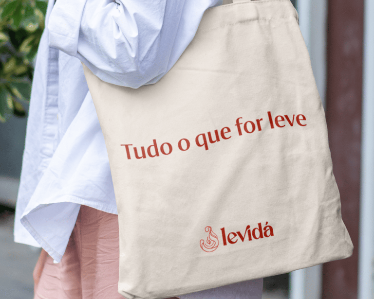 a woman in a white shirt and pink pants with a baguet bag