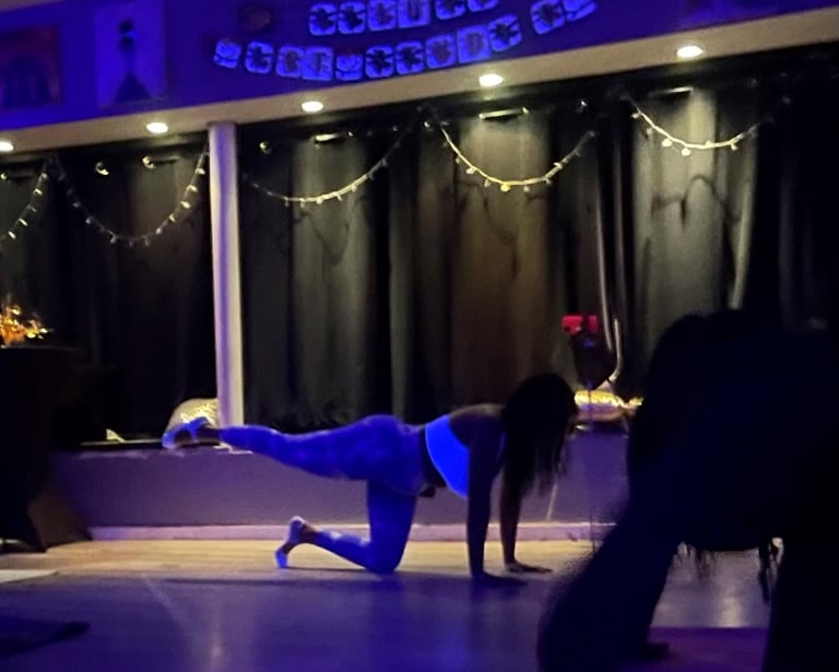 a woman doing a pilates pose on a yoga mat in a class