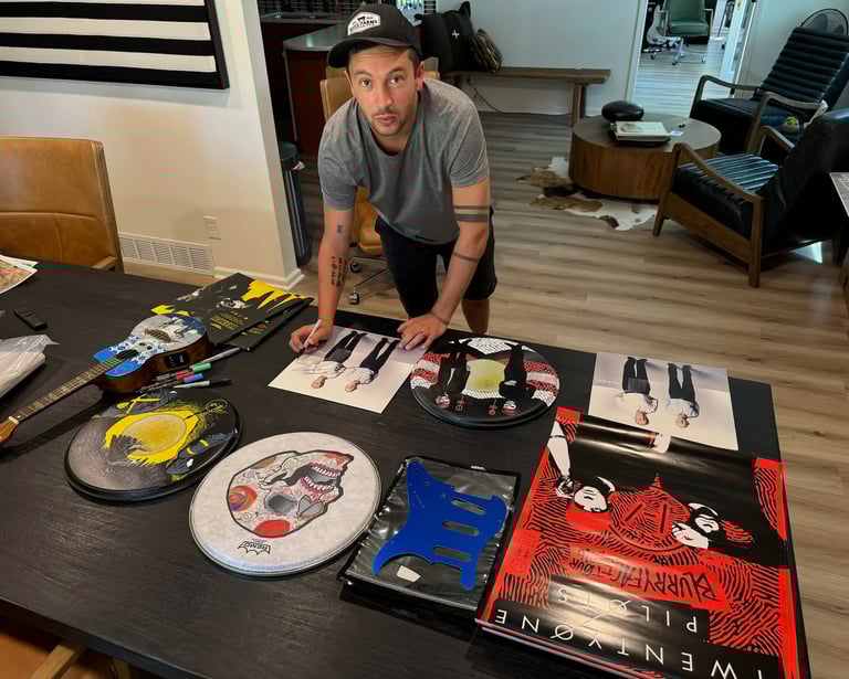Tyler Joseph signing items for charity event 2023