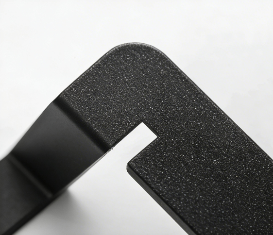 Close-up of a matte black textured metal bracket with a precision cut-out slot on a white background.