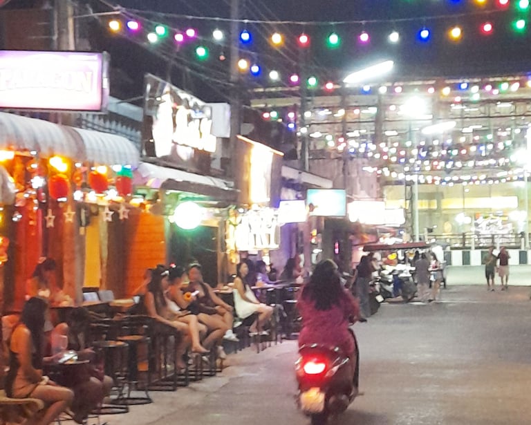 Thai women sat outside bars on Soi 80, Hua Hin in Thailand
