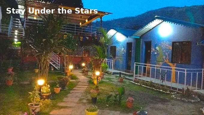  Night view of Jungle Lore Resort luxury cottages with garden lights