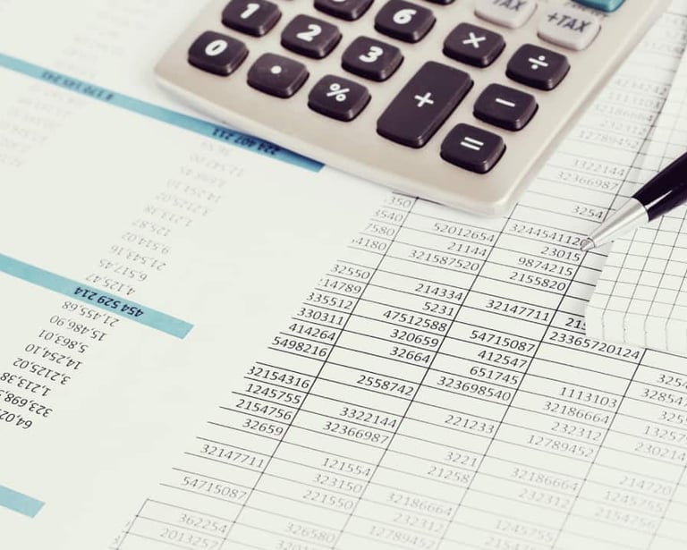 a calculator and pen on a paper with a pen and a pen