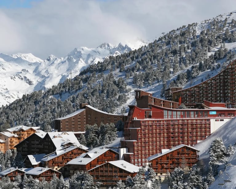 Snow-covered Les Arcs mountain resort buildings showing Charlotte Perriand’s alpine design connectio