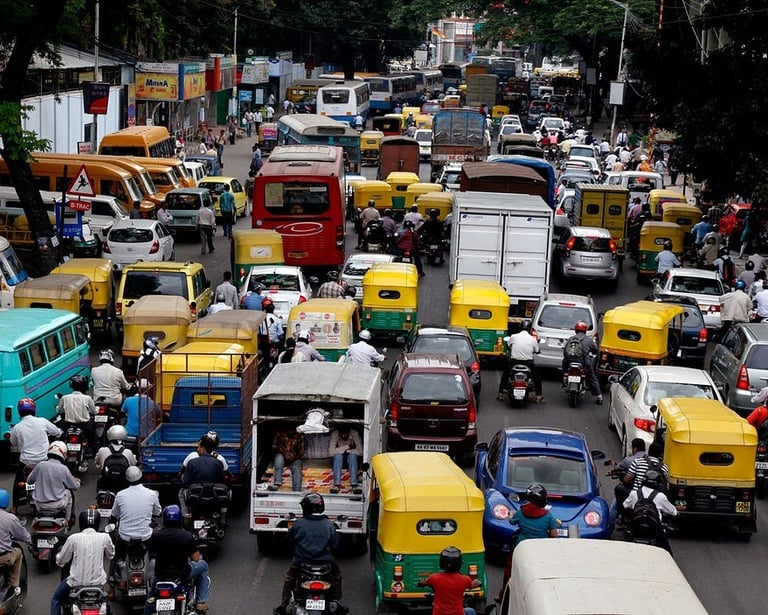 traffic chaos of rickshaws and buses on a road