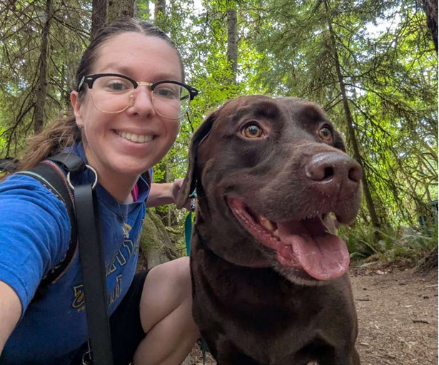 dog walker with a happy dog in Squaxin Park, Olympia WA