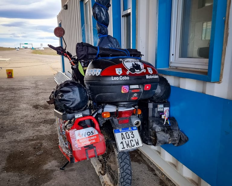 a motorcycle parked next to a building with a motorcycle