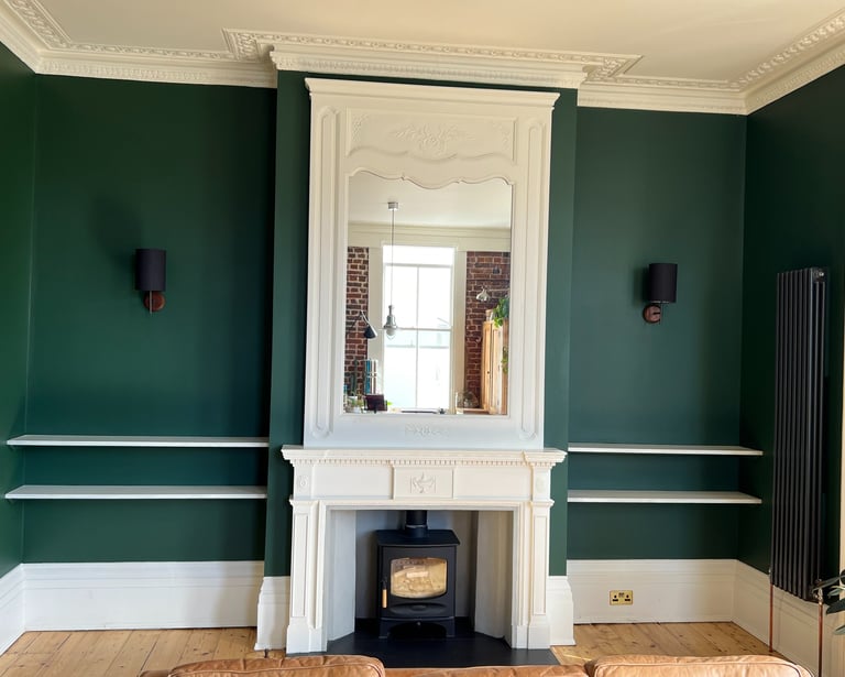 Luxury dark green living room painting in Haywards Heath Sussex with classic fireplace