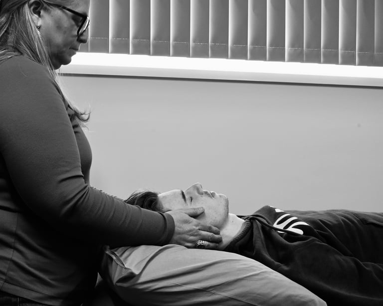 Woman giving Reiki to man