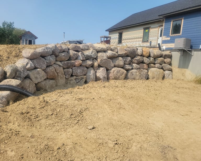 boulder wall behind residential home