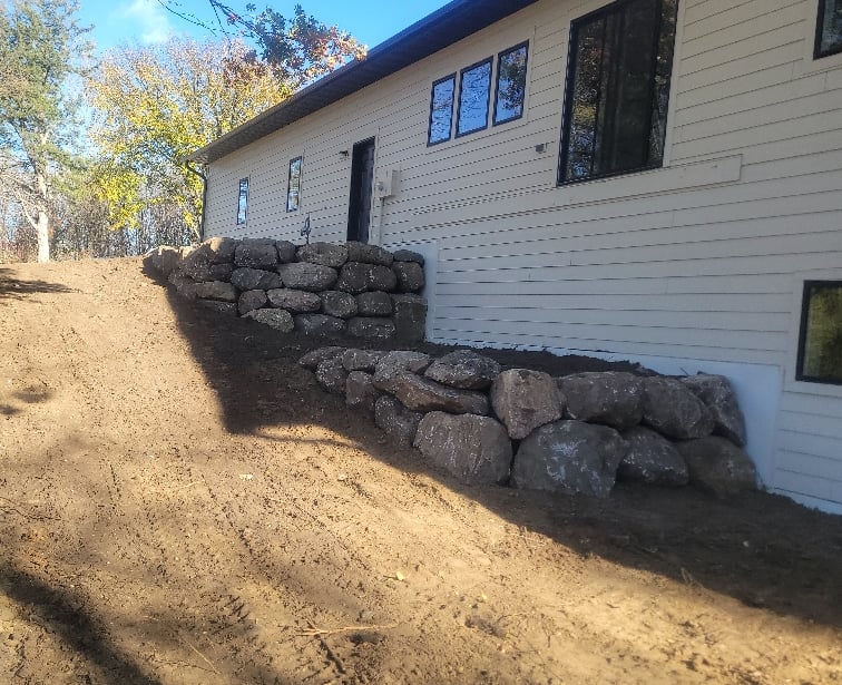 boulder wall behind home