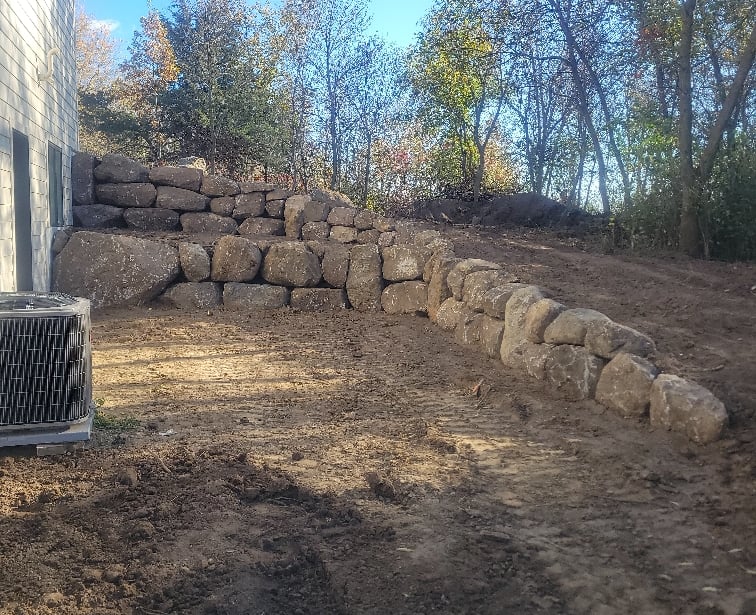 boulder wall next to residential home