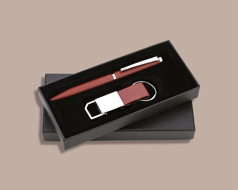 New joinee kit featuring a premium pen and leatherette keychain in a minimalist box.