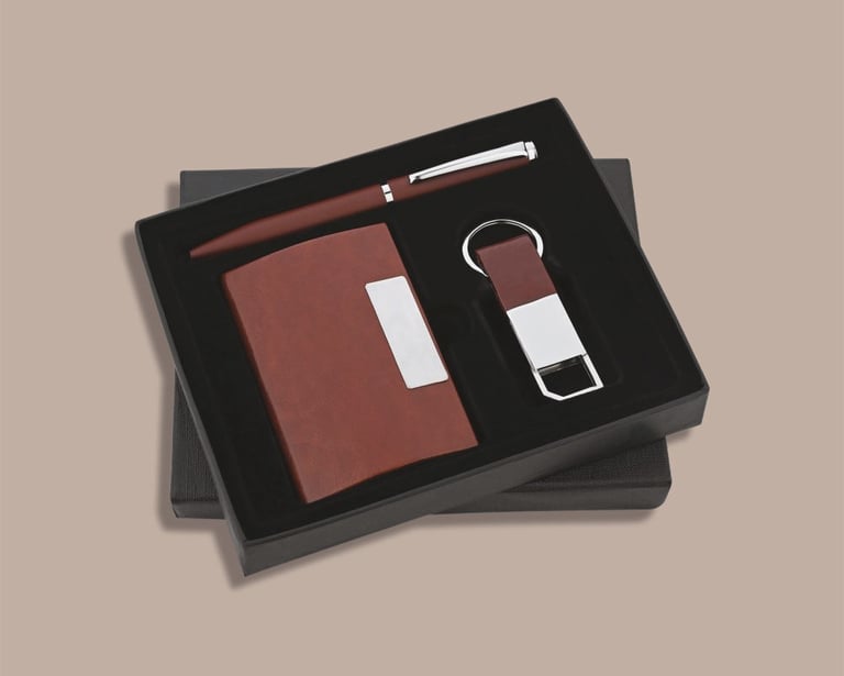 Minimalist employee new joinee kit with a pocket diary, matching pen, and keychain.