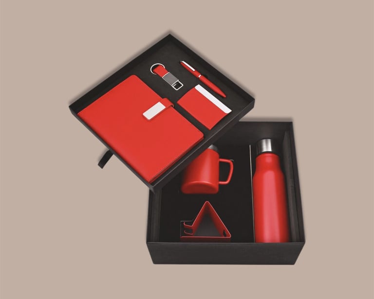 Employee new joinee kit mega hamper with a red bottle, mug, tech stand, and notebook.
