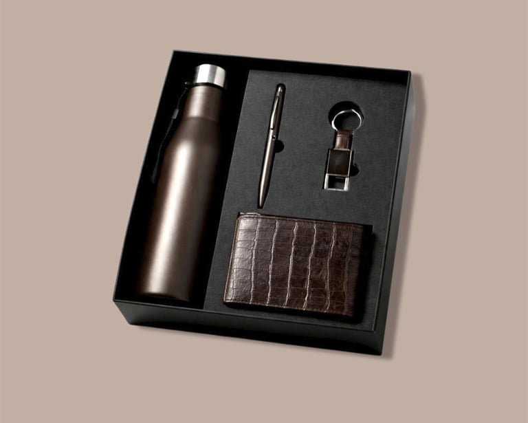 All-brown new joinee kit with a matte flask, textured wallet, and minimalist pen.