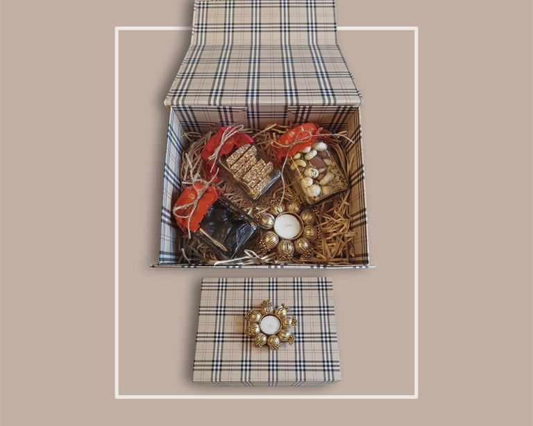 Monochrome plaid box filled with artisanal snacks for premium corporate festive gifting.