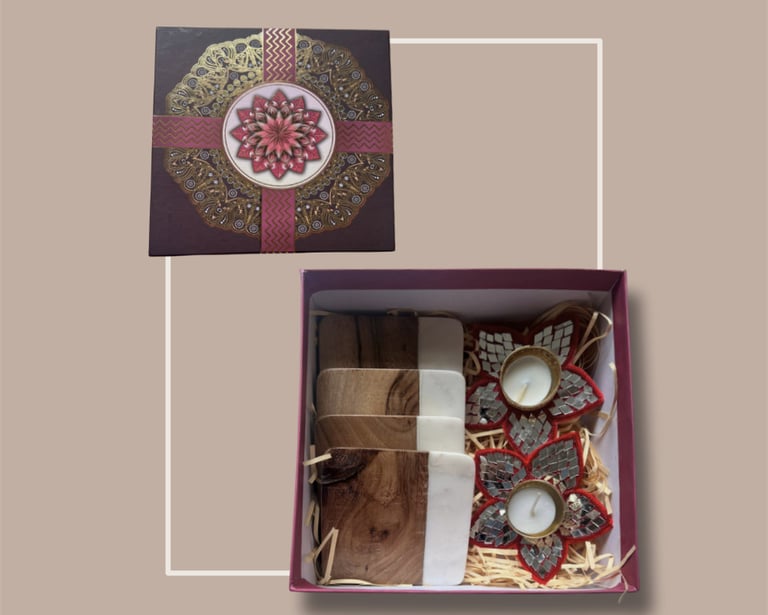 Deep red festive gifting set with a mandala lid, treats, and a floral t-light diya.
