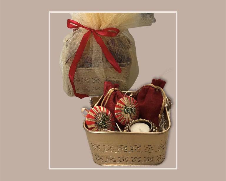 Golden filigree basket with traditional red potli bags for corporate festive gifting.