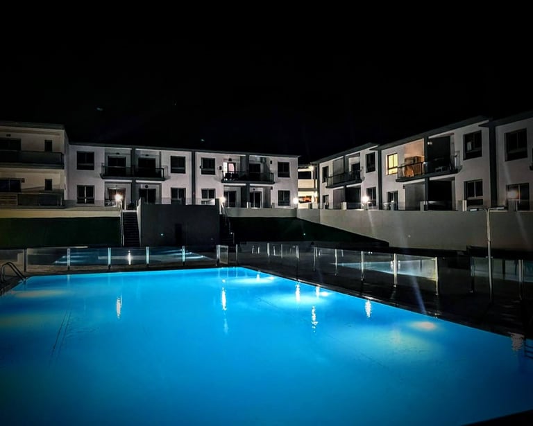 a pool with a pool and a waterfall in the background