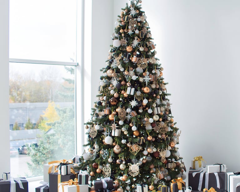 a christmas tree with presents and presents on a white floor