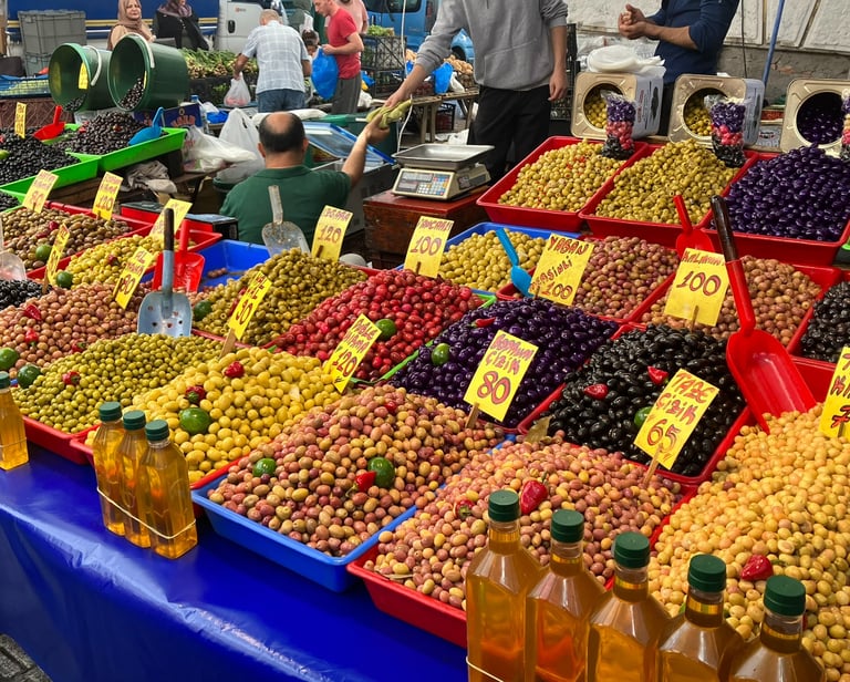 a table with olives and olive oil bottles