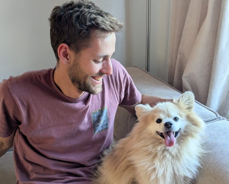 Tom and Lupin the Pomeranian sat on the sofa together