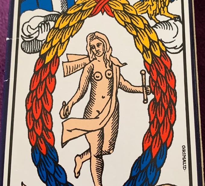 a tarot card deck with a picture of a man holding a sword
