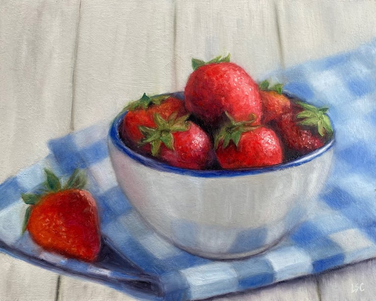 An original oil painting of strawberries in a bowl on a blue & white tablecloth