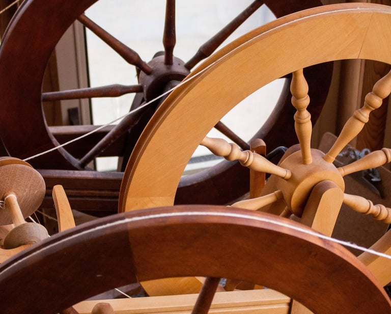 Spinning wheels lined up next to each other.