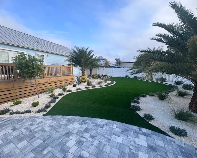 backyard landscape design with syntenic turf and pavers