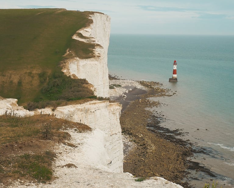Beachy Head UK view of white cliff in england with light house