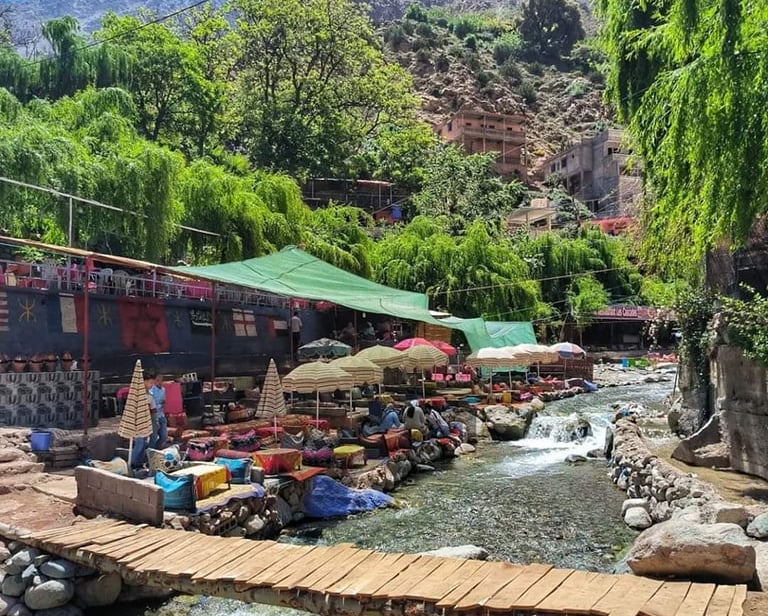 morocco marrakech  a bridge over a river with a wooden bridge