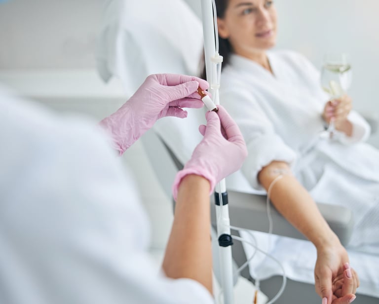 nurse giving an iv drip of vitamin to a woman