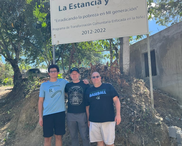 three men standing in front of a sign that says la estrancia y est