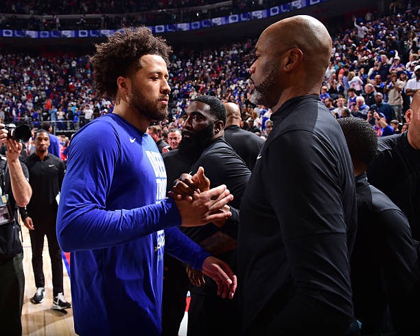 Cade Cunningham (left) and Magic head coach Jamahl Mosley (right) shake hands following the Pistons game 7 victory.